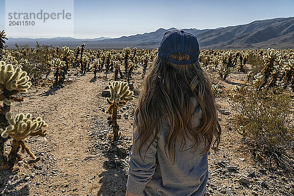 Woman amongst the Cholla Cactus forest in Joshua Tree National Park  California.