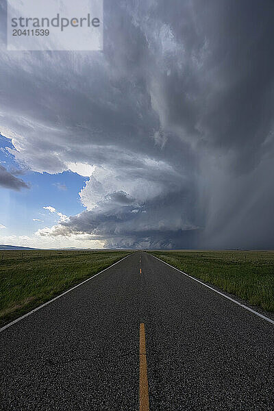 Dramatic clouds associated with a very strong supercell thunderstorm in Western New Mexico. Road leading directly into the storm.