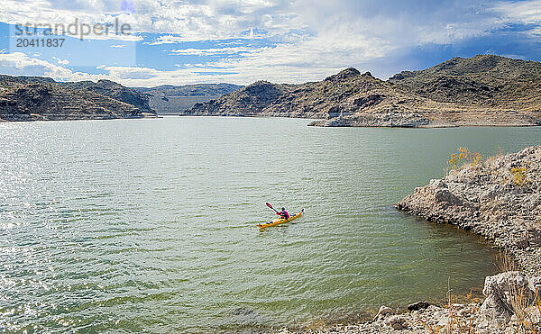 USA  Arizona  Alamo Lake State Park  Kayaker paddling in desert lake.