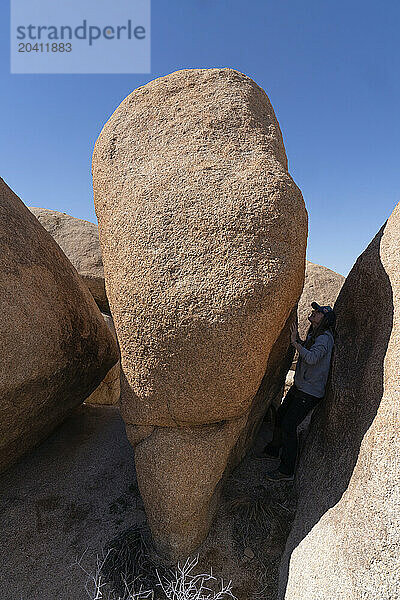 Woman exploring the beautiful rocks in Joshua Tree National Park  California.