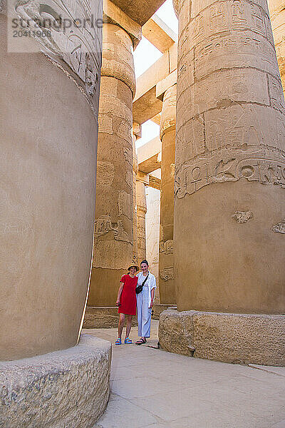 GAN 15482  Gan 15483  Two female tourists standing among the Giant columns' of Karnak temple  Luxor Egypt