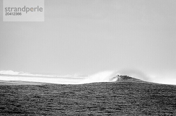 A powerful wave breaks over reef.