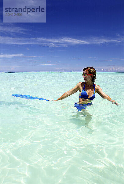 Maldives  portrait of attractive young woman relaxing on beach