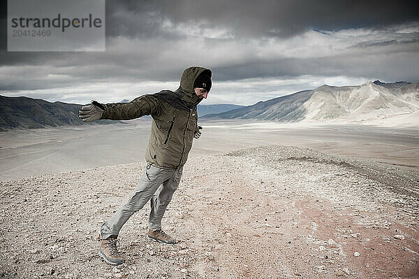 A mountaineer leans into a strong wind in the Valley of Ten Thousand Smokes  Katmai National Park  Alaska.