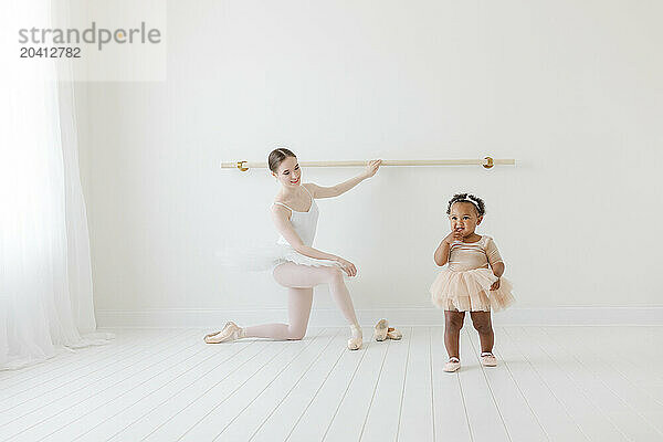 baby in tutu runs to mom at ballet lesson