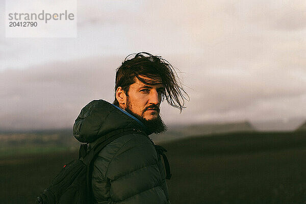 Man traveler with a backpack in Iceland.