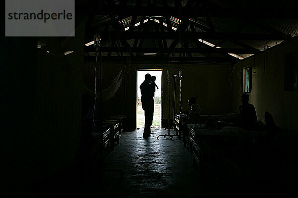 A man holds his baby at a clinic in Lira  Uganda.