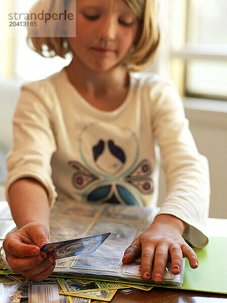 A girl organizes her card collection.