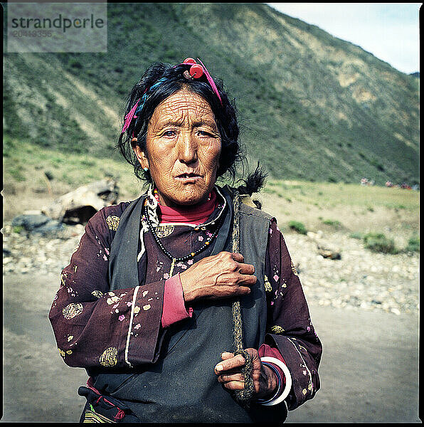 A Tibetan Khampa women poses for a portrait alongside the Salween River in Northeastern Tibet Autonomous Region  China.