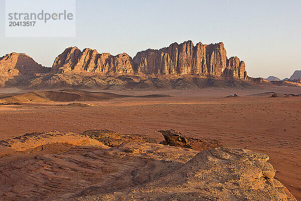 Desert rock formations in the middle east with sand and sky