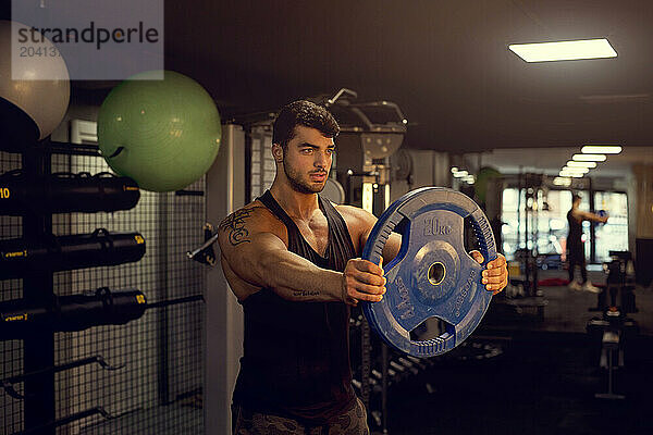 Young Body Builder Training In The Gym