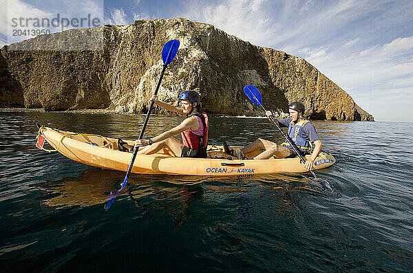 A couple sea kayaks along the shores of Santa Cruz Island  California.