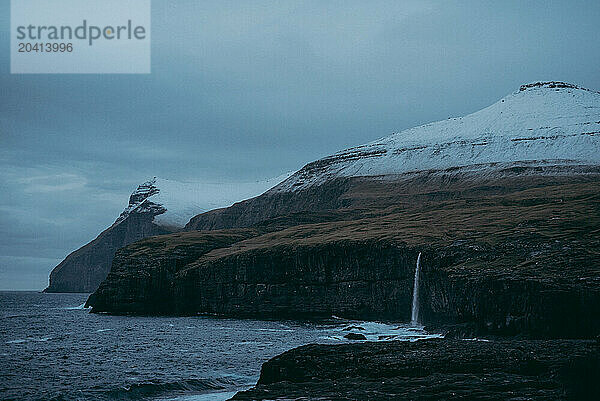 dusk next to a mountain waterfall