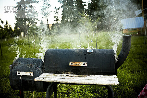 A large smoking bbq in the backyard.