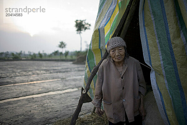 A woman looks out from her tent following an earthquake in Sichuan  China.