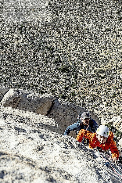 Father and son rock climbing in Joshua Tree National Park