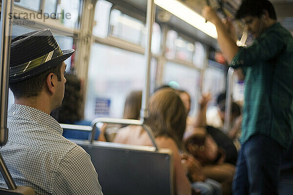 Commuters riding on a public bus.