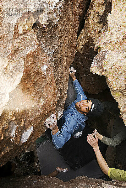 A Young African American man boulders in Hueco Tanks State Park near El Paso  Texas.