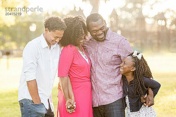 Family of four laughing together