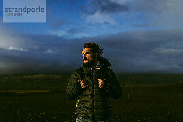 Man traveler with a backpack in Iceland.