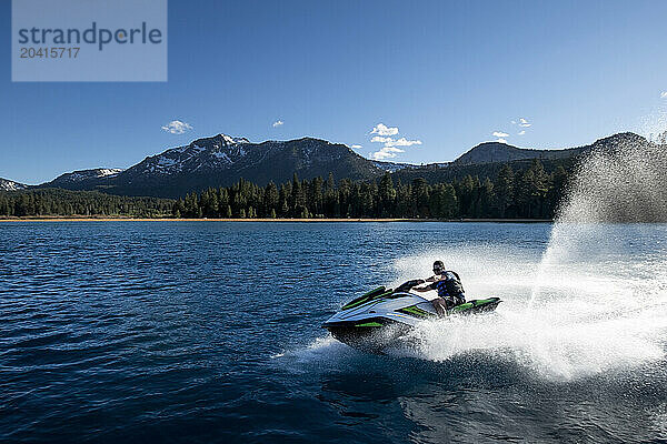 A man grins as he rides a WaveRunner on Lake Tahoe  California.