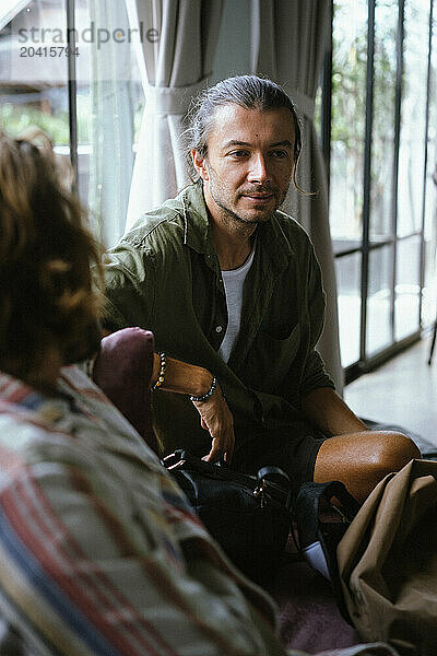 Male friends talking at a friendly party.