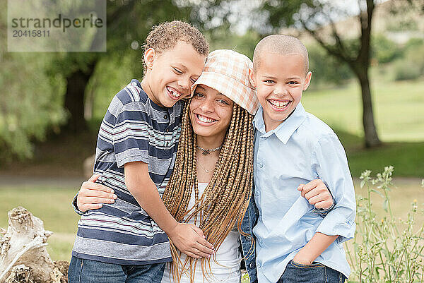 Siblings hugging and laughing together