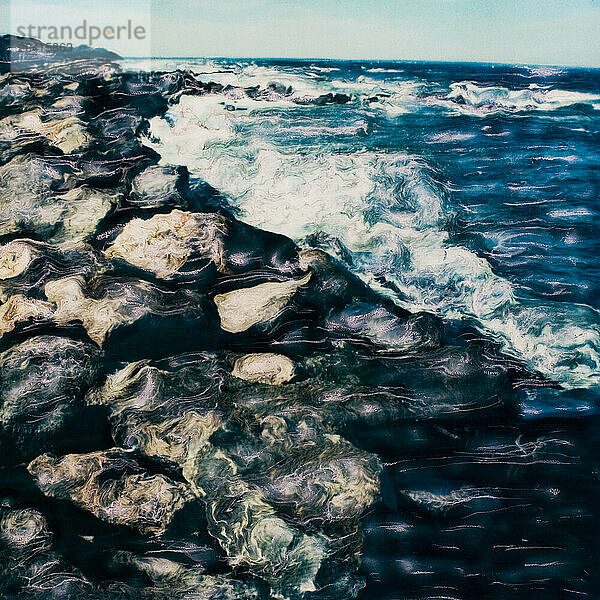 Polaroid manipulation of waves crashing against a rock jetty. (polaroid manipulation)