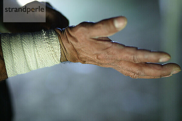 An acrobat wraps his wrists moments before performing at the Circus.