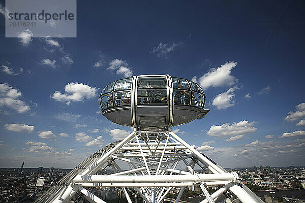 The London Eye  the big Ferris wheel that weighs 2 100 tonnes  is 135m in high  has a circumference of 424 meters and can carry 800 people at once  sit on the banks of the river Th