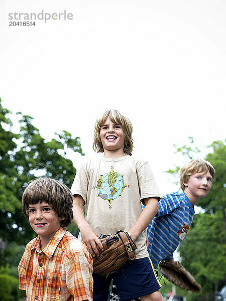 boys have an afternoon catch in the street