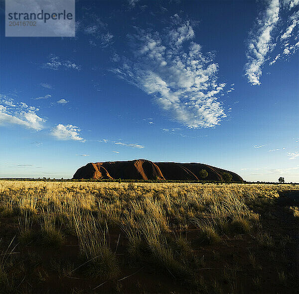 The sunrises over Uluru  Australia's sacred sandstone rock  more commonly known as Ayers Rock.