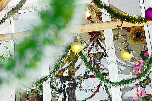 Christmas decorations adorn a small roadside capilla at a roadside arts and crafts store near Chacalal  Mexico.