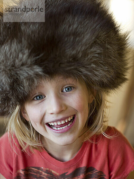 girl in fur hat makes funny face