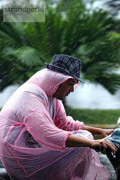 Cat Ba islandpeople riding on motorcyclesRainning