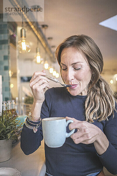 Woman having a capuccino in a bar  vintage modern style  barcelo