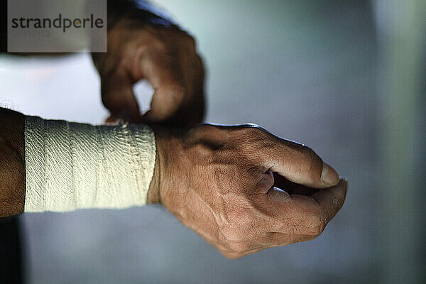 An acrobat wraps his wrists moments before performing at the Circus.