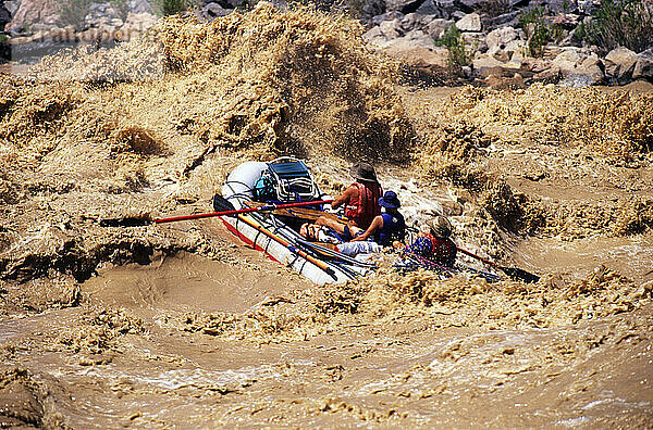 Whitewater rafters navigate the large waves of Hermit Rapid on the Colorado River in Grand Canyon National Park  Arizona.