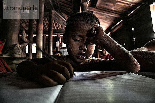 novice monks studying inside one of the temples of Ava. Mandalay. Myanmar