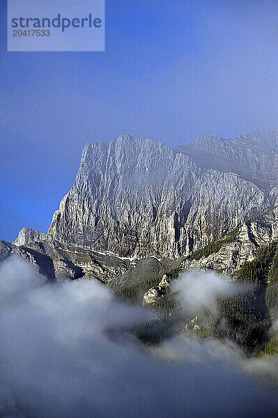 Peaks above Canmore  Alberta Canada emerge from the morning fog on 7/19/2010