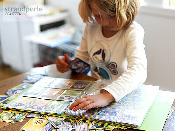 A girl organizes her card collection.