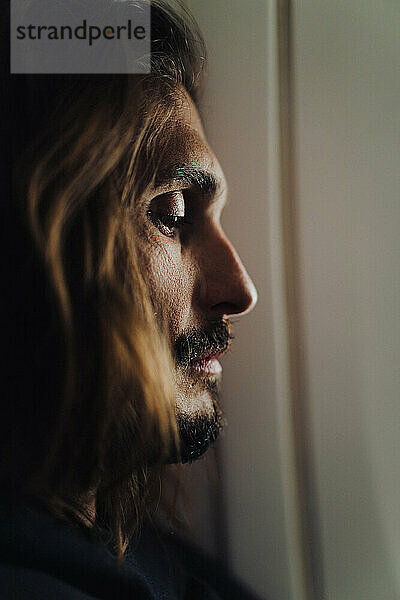 Portrait of a man on an airplane  close-up  light from the eluminator.