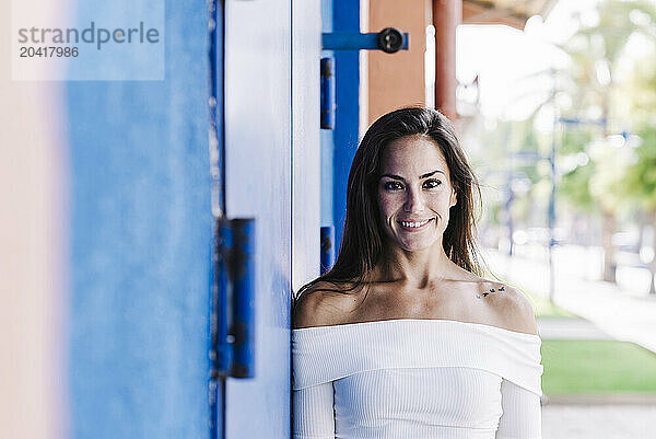 Portrait confident smiling young woman on urban street