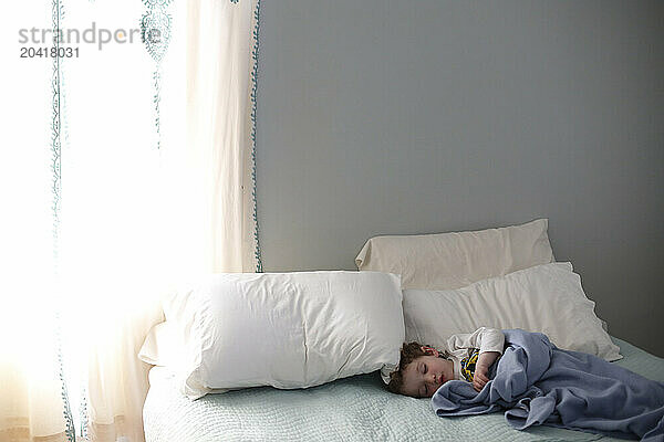 Boy sleeping in bed