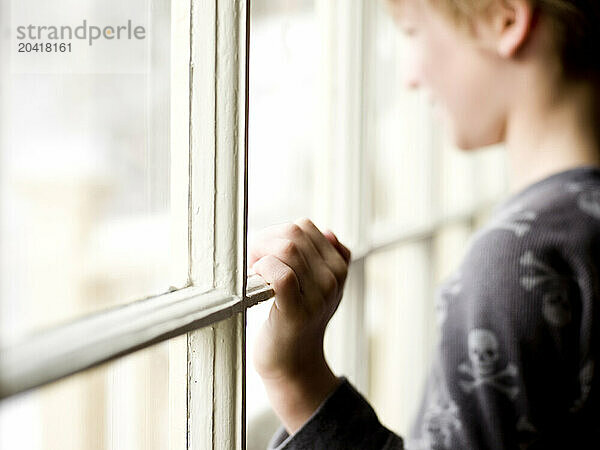 boy looks out window