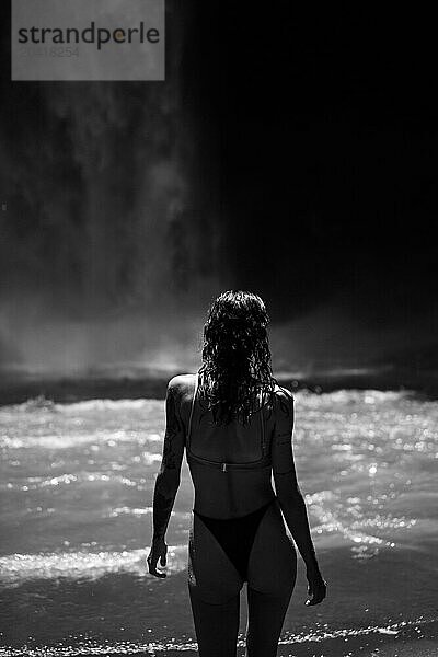 Woman traveler at the waterfall.