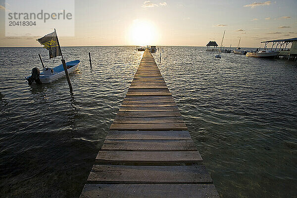 Sunrise over a wooden pier on Caye Caulker  Belize