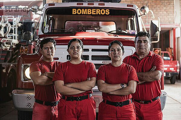 Portrait of a team of male and female firefighters at fire station