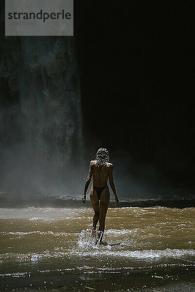 Woman traveler at the waterfall Nung Nung.