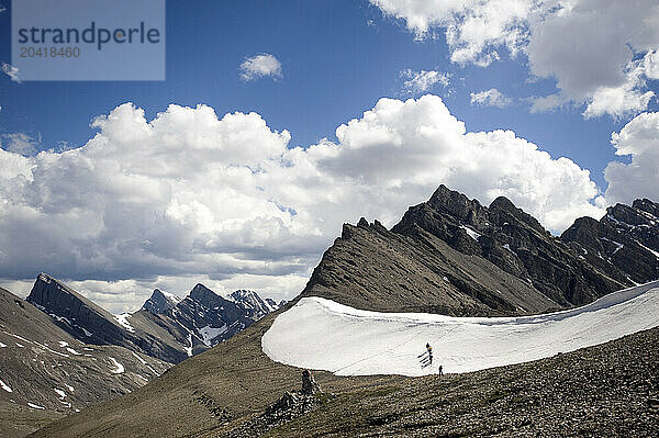 6 people head over snowy Badger Pass in summer conditions in Banff NP  Alberta Canada on 7/22/2010